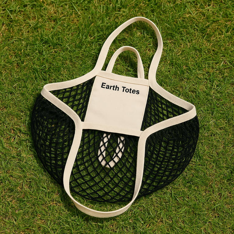 black & white string bag lying on grass