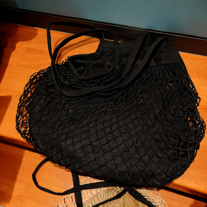 Black mesh bag on a wooden surface